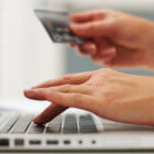 Person with debit card, ready to pay for a product online