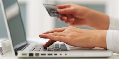 Person with debit card, ready to pay for a product online