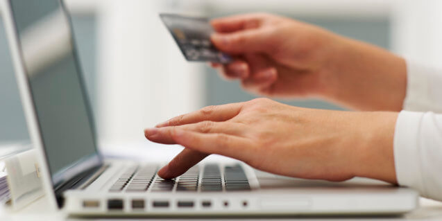 Person with debit card, ready to pay for a product online